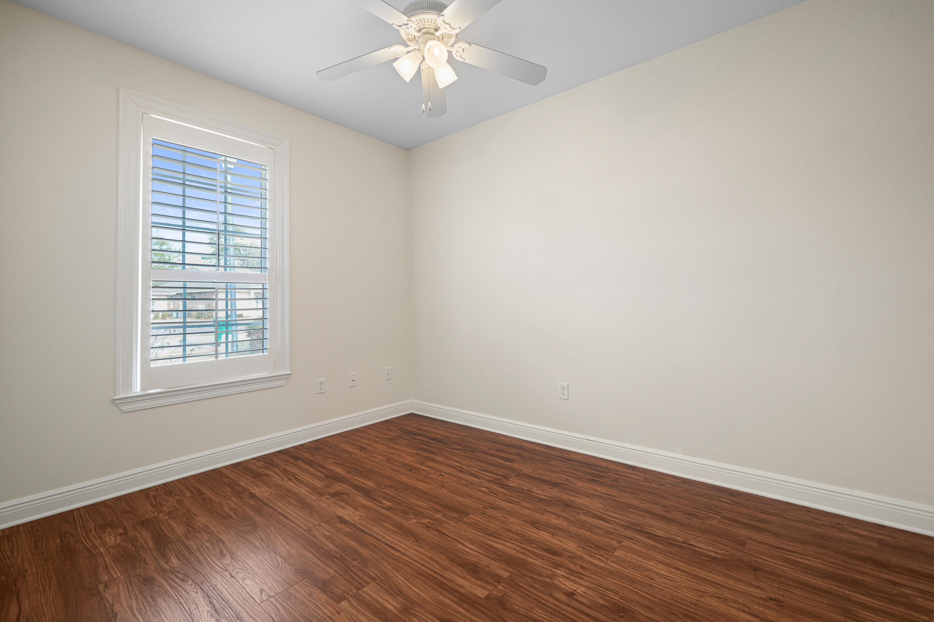 4116 Callaway Drive Niceville, FL 32578 - Photo 37 of 53 a view of an empty room with wooden floor and a window