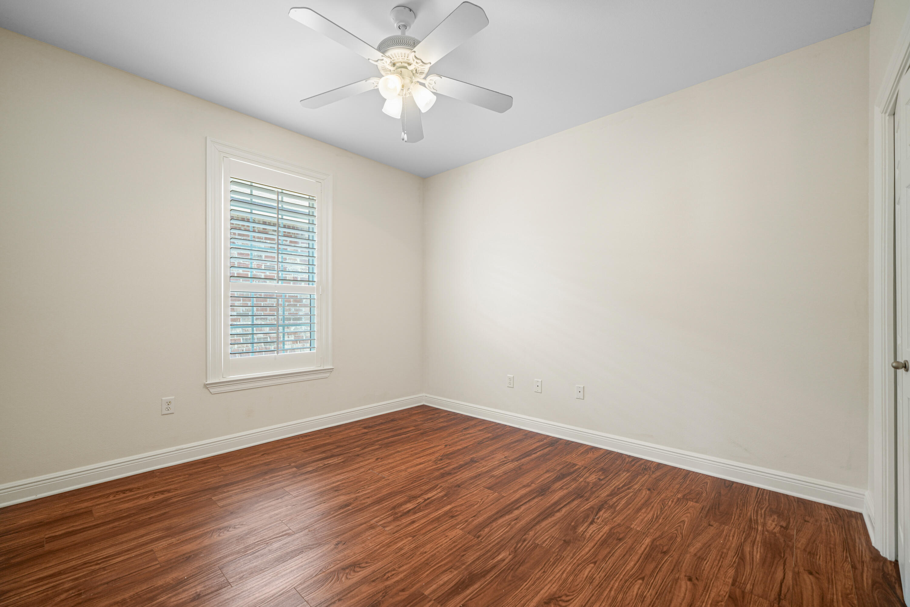 4116 Callaway Drive Niceville, FL 32578 - Photo 41 of 53 an empty room with wooden floor and window