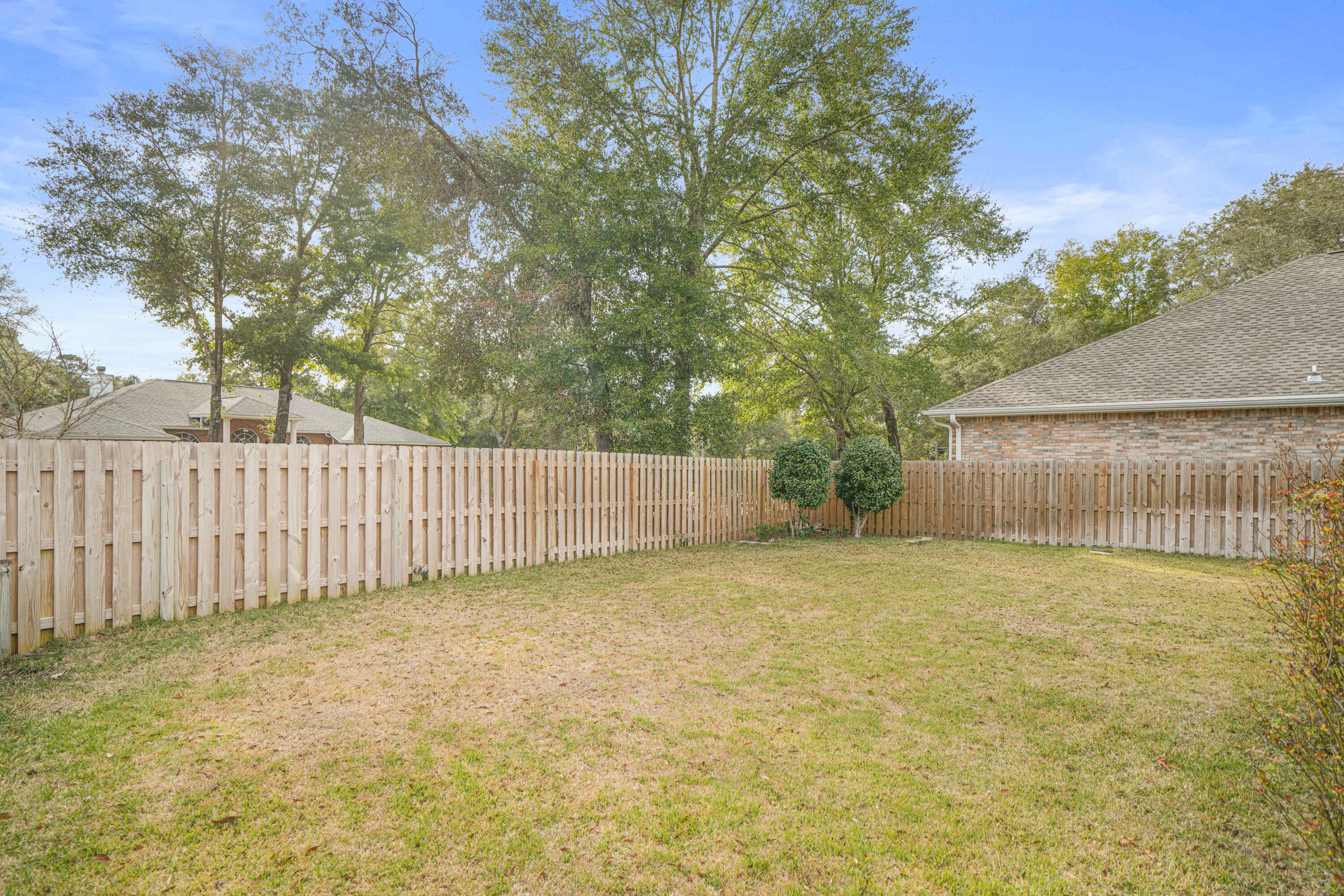4116 Callaway Drive Niceville, FL 32578 - Photo 9 of 53 a view of a yard with wooden fence