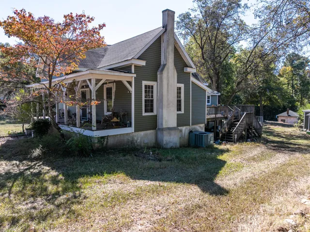 a view of a house with yard and sitting area