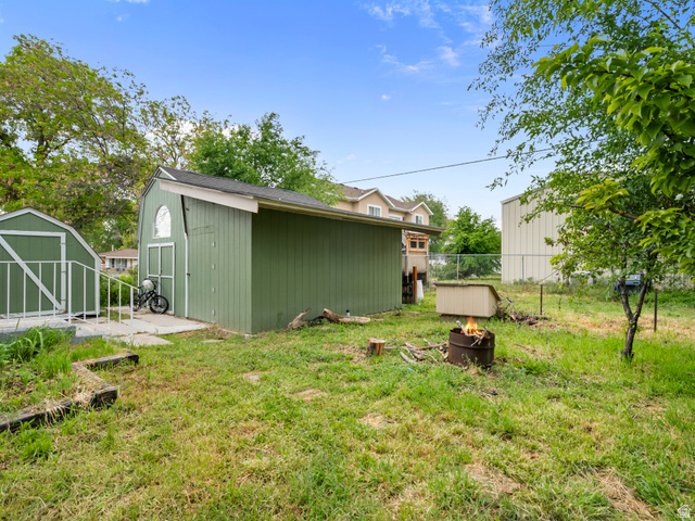 510 Canyon Road Ogden, UT 84404 - Photo 25 of 30 View of yard with a shed and an outdoor fire pit