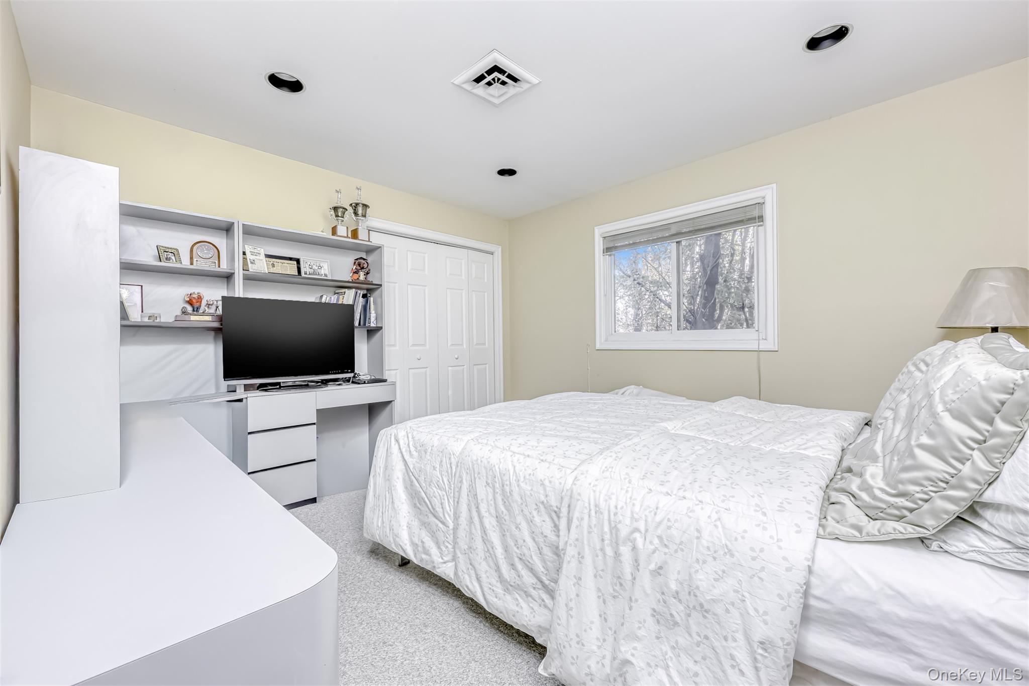 8 Kings Gate Road Suffern, NY 10901 - Photo 16 of 23 a bedroom with a bed and a flat screen tv