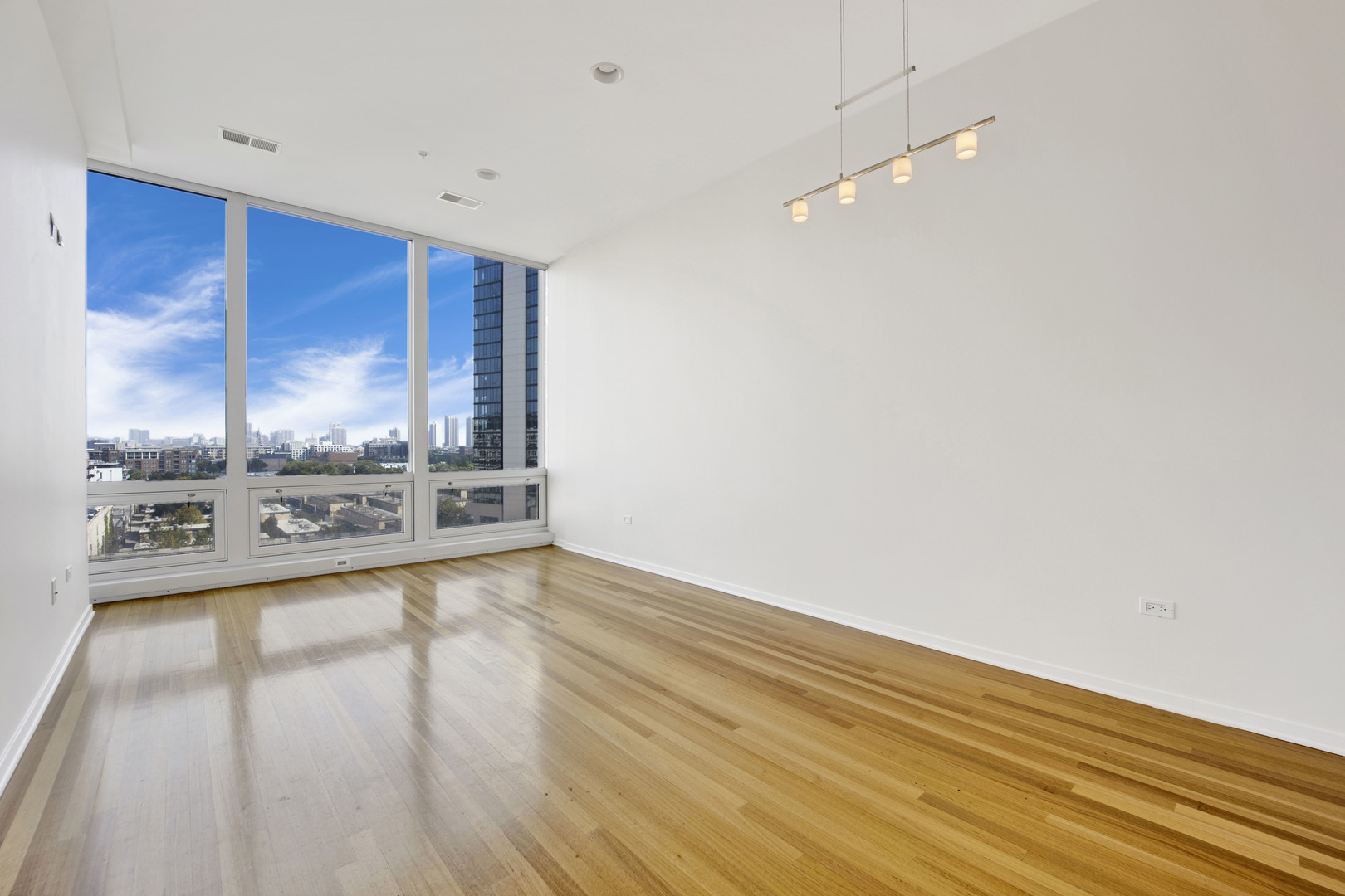 Undisclosed Address Chicago, IL 60654 - Photo 4 of 22 a view of a hardwood floor and a ceiling fan in a room