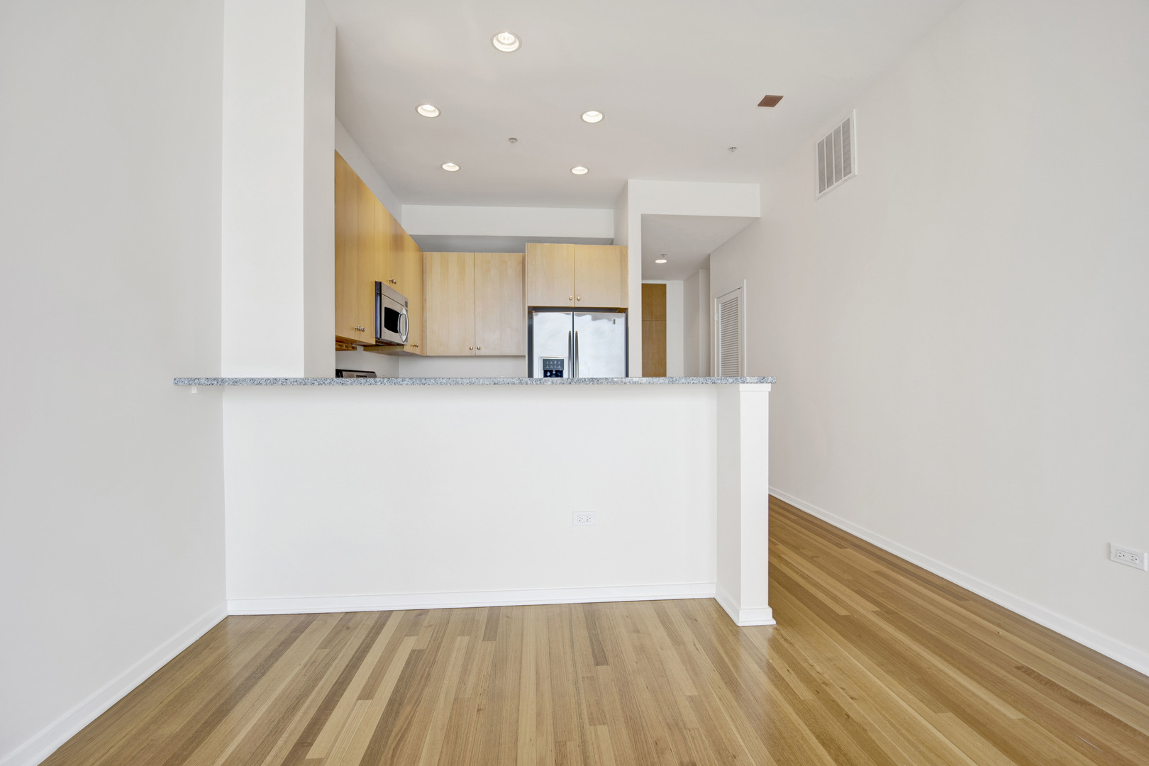 Undisclosed Address Chicago, IL 60654 - Photo 7 of 22 a view of a kitchen with wooden floor