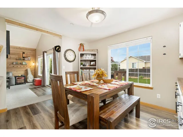 a living room with furniture a table and a large window