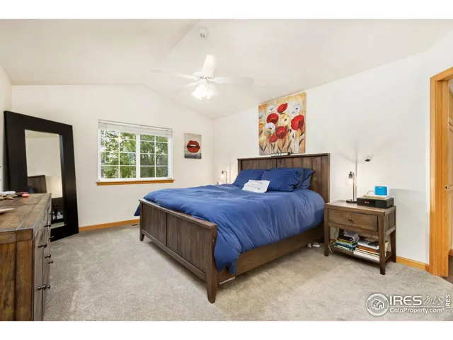 a spacious bedroom with a bed and a chandelier