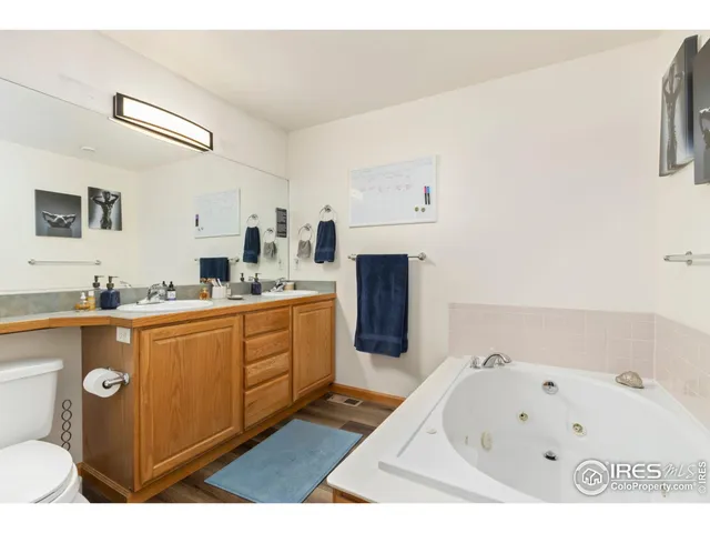 a large white kitchen with a sink a stove a microwave and a refrigerator