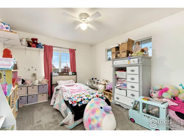 a bedroom with furniture a flat screen tv and a bed