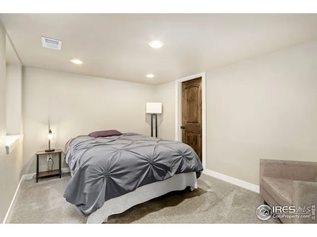 a bedroom with a bed and a night stand