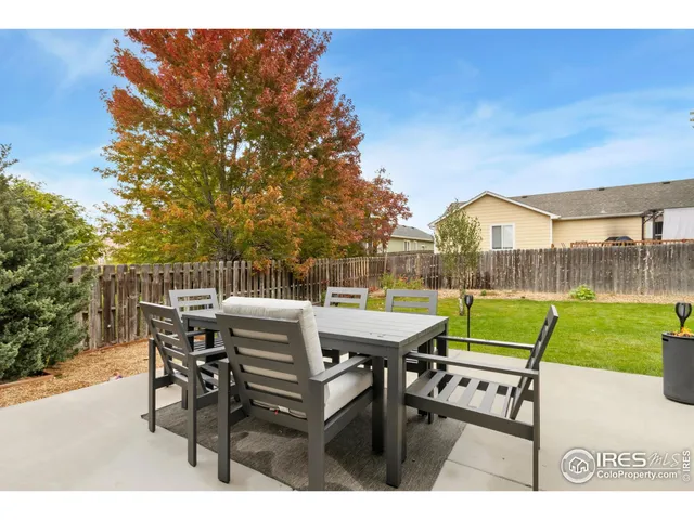 a view of a patio with table and chairs