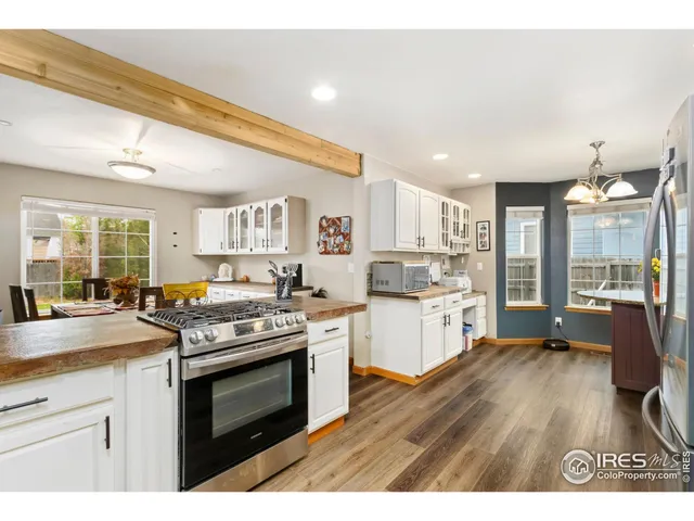 a kitchen with stainless steel appliances granite countertop a stove and cabinets