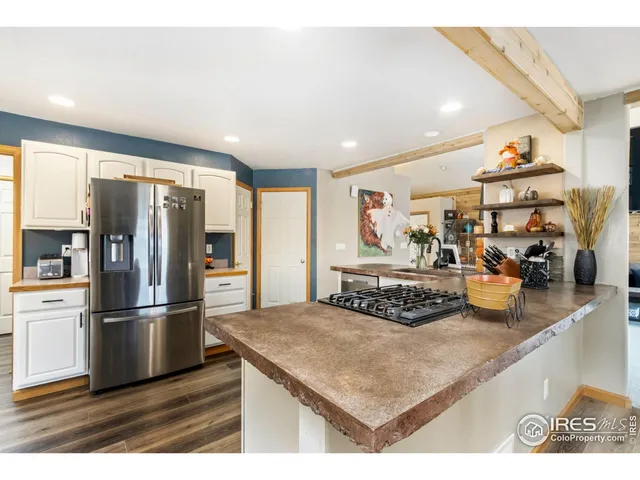 a kitchen with stainless steel appliances granite countertop a refrigerator and a sink