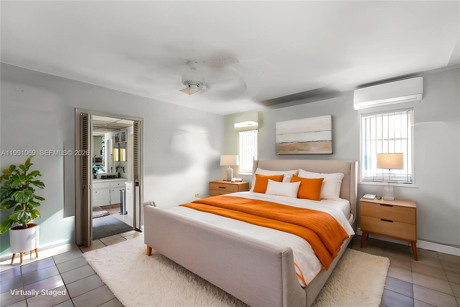 5171 Southwest 20th Street Plantation, FL 33317 - Photo 17 of 30 a bedroom with a bed and potted plant