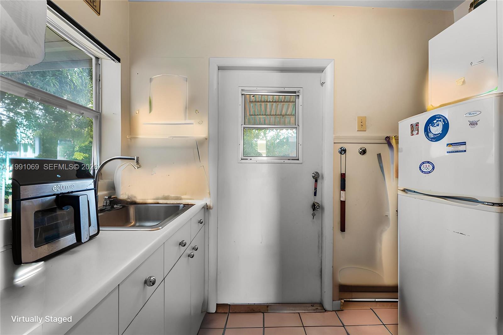 5171 Southwest 20th Street Plantation, FL 33317 - Photo 18 of 30 a kitchen with stainless steel appliances a refrigerator sink and cabinets