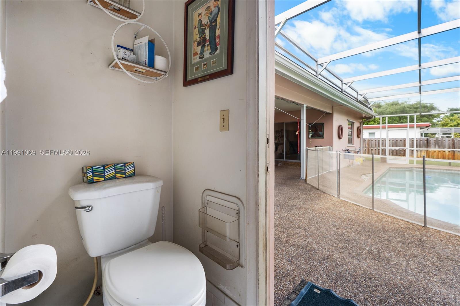 5171 Southwest 20th Street Plantation, FL 33317 - Photo 19 of 30 a white toilet sitting next to a bathroom sink