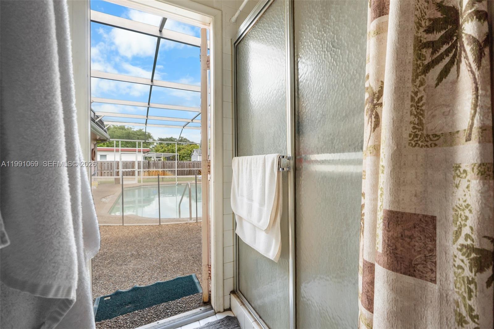 5171 Southwest 20th Street Plantation, FL 33317 - Photo 20 of 30 a bathroom with a glass shower door