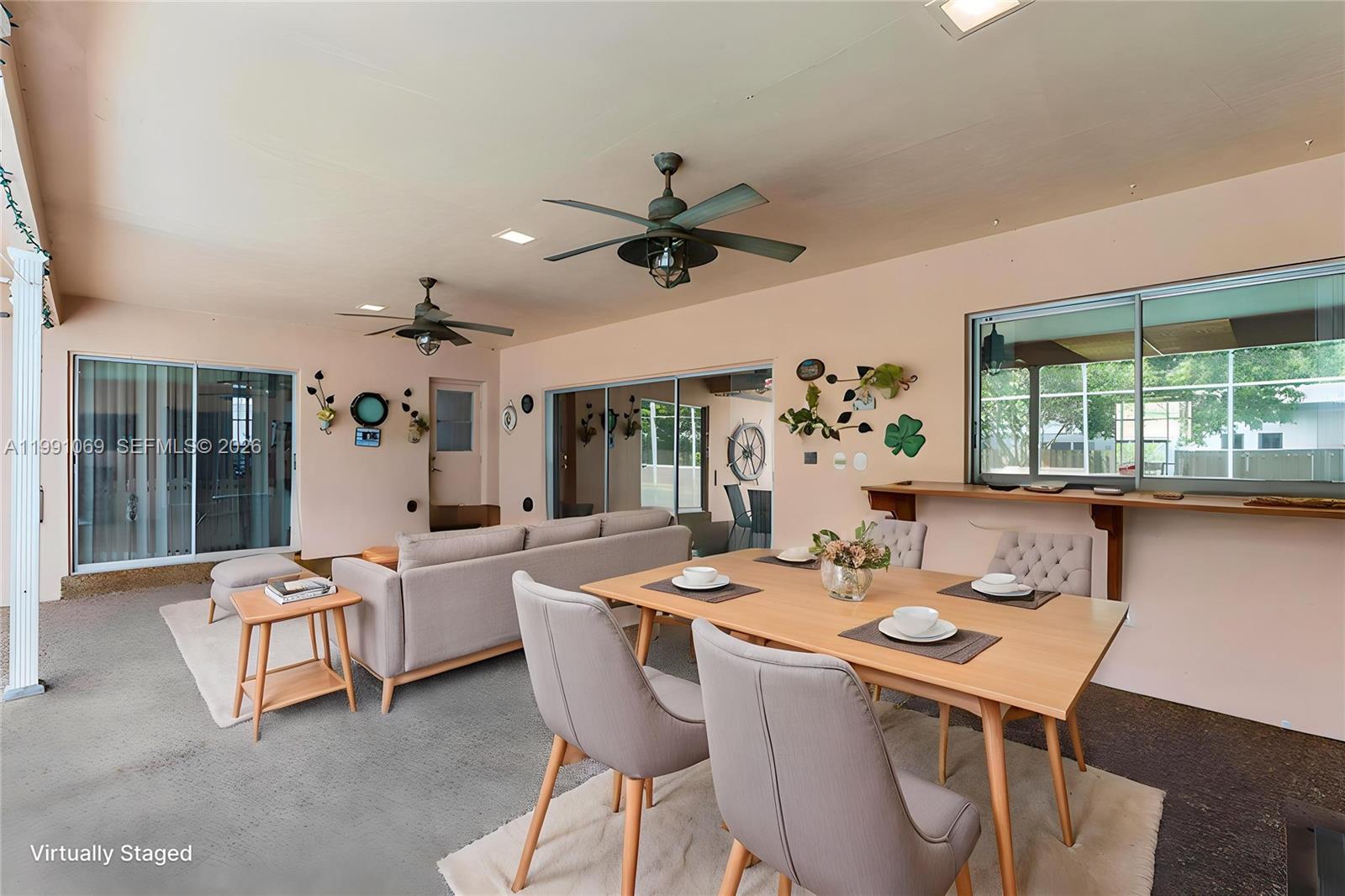 5171 Southwest 20th Street Plantation, FL 33317 - Photo 21 of 30 a view of a dining room with furniture window and outside view