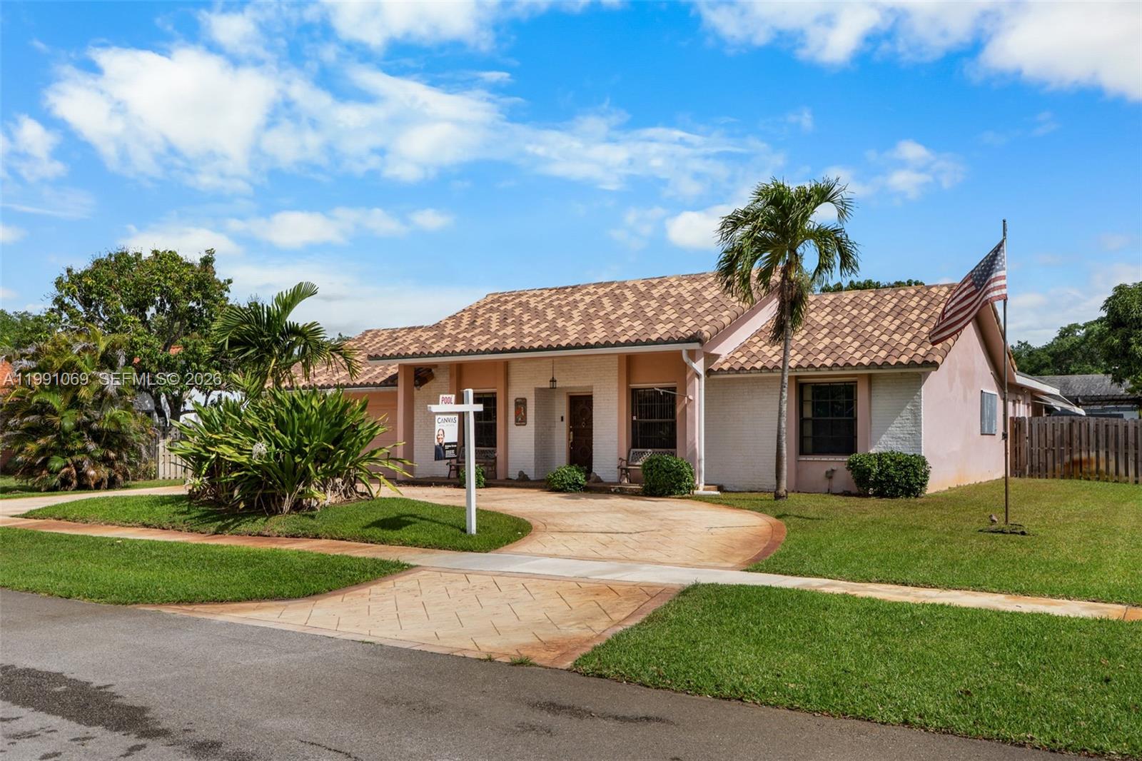 5171 Southwest 20th Street Plantation, FL 33317 - Photo 3 of 30 a front view of a house with a yard and potted plants