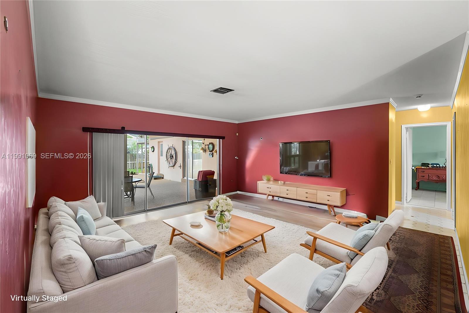 5171 Southwest 20th Street Plantation, FL 33317 - Photo 6 of 30 a living room with furniture and a flat screen tv