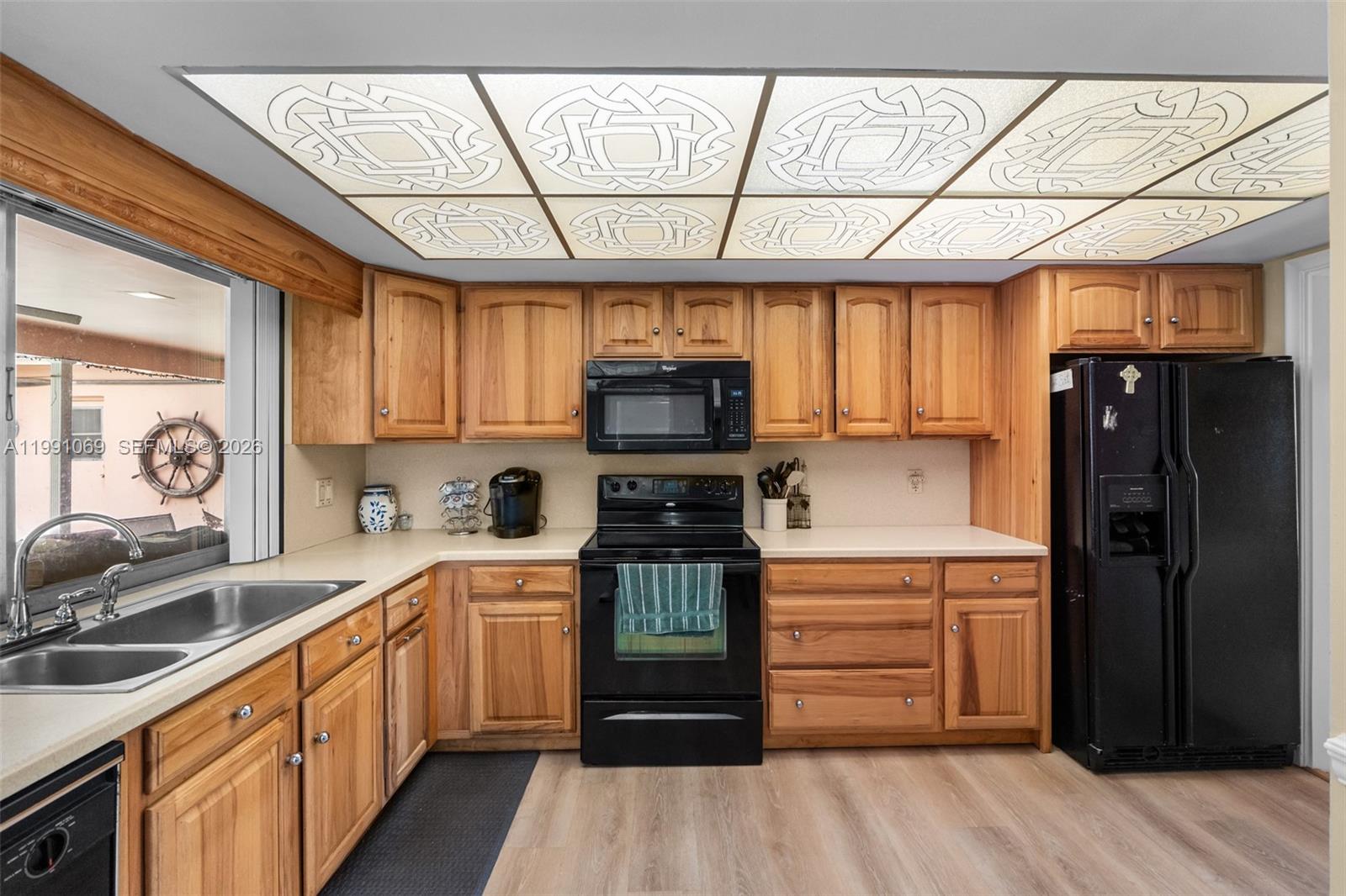 5171 Southwest 20th Street Plantation, FL 33317 - Photo 7 of 30 a kitchen with stainless steel appliances a refrigerator sink and cabinets