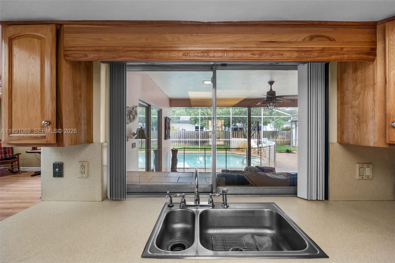 5171 Southwest 20th Street Plantation, FL 33317 - Photo 9 of 30 a kitchen with a sink a counter top space and furniture