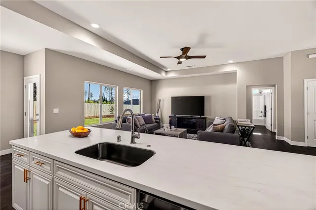 a kitchen with sink stove and cabinets