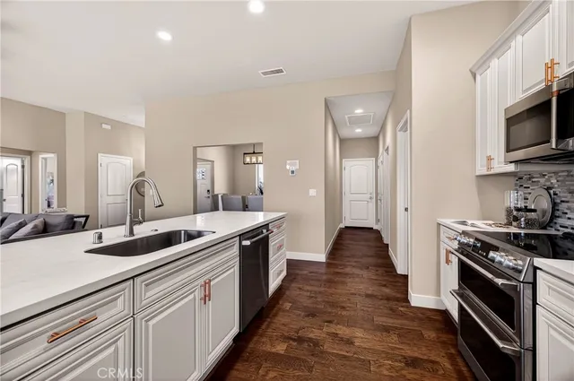 a view of a dining room with furniture wooden floor and a chandelier