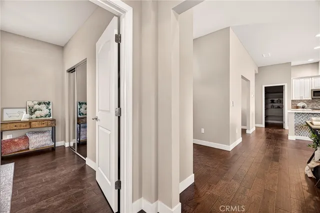 a view of a hallway view with wooden floor and furniture