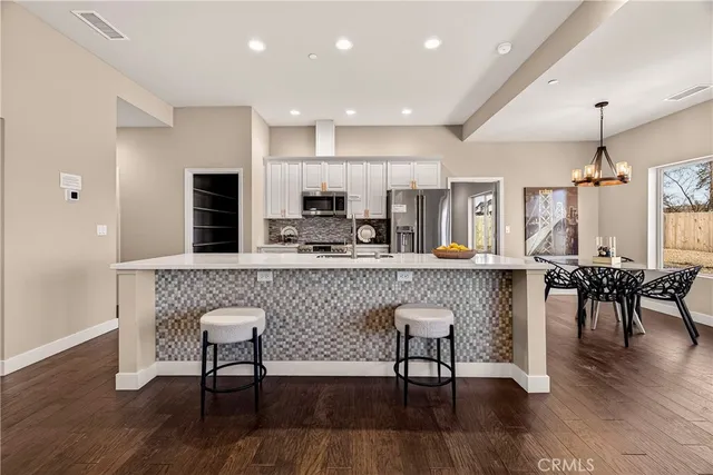 a kitchen with a sink a counter top stainless steel appliances and cabinets