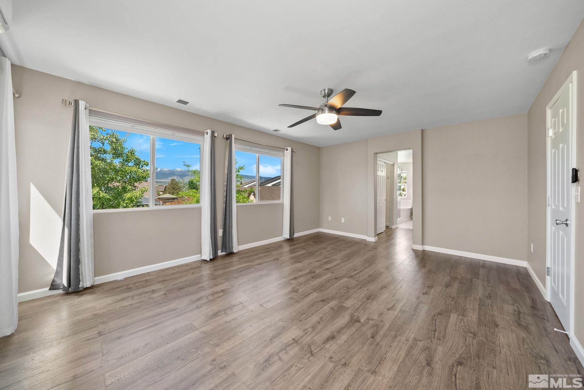 2270 Big Trail Circle Reno, NV 89521 - Photo 20 of 40 a view of an empty room with a window and wooden floor