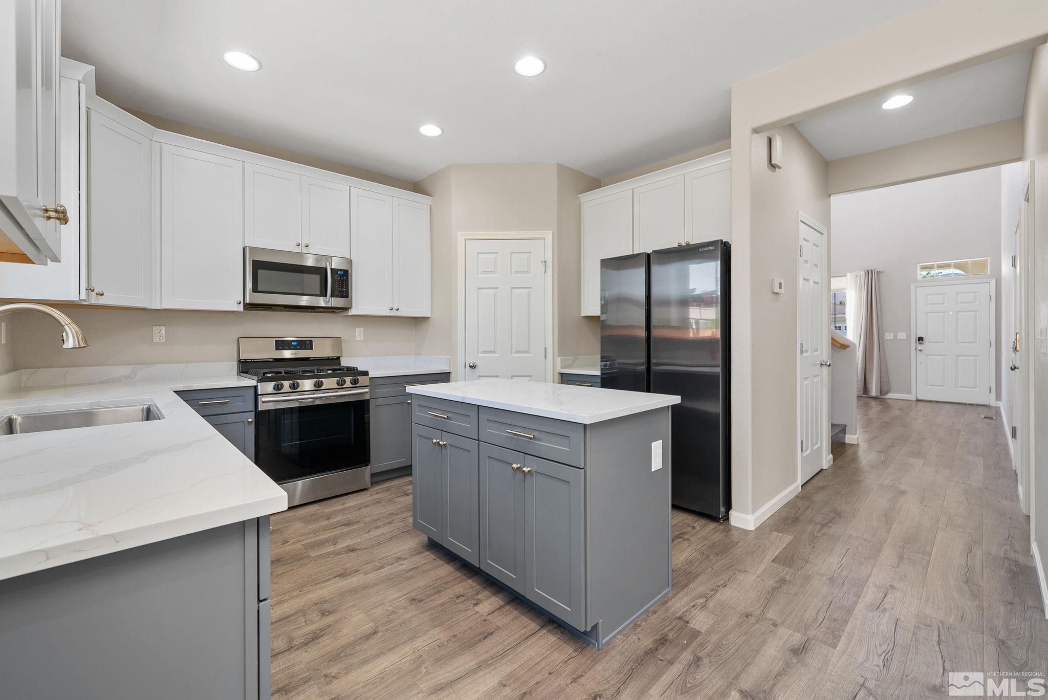 2270 Big Trail Circle Reno, NV 89521 - Photo 4 of 40 a kitchen with a refrigerator stove and sink