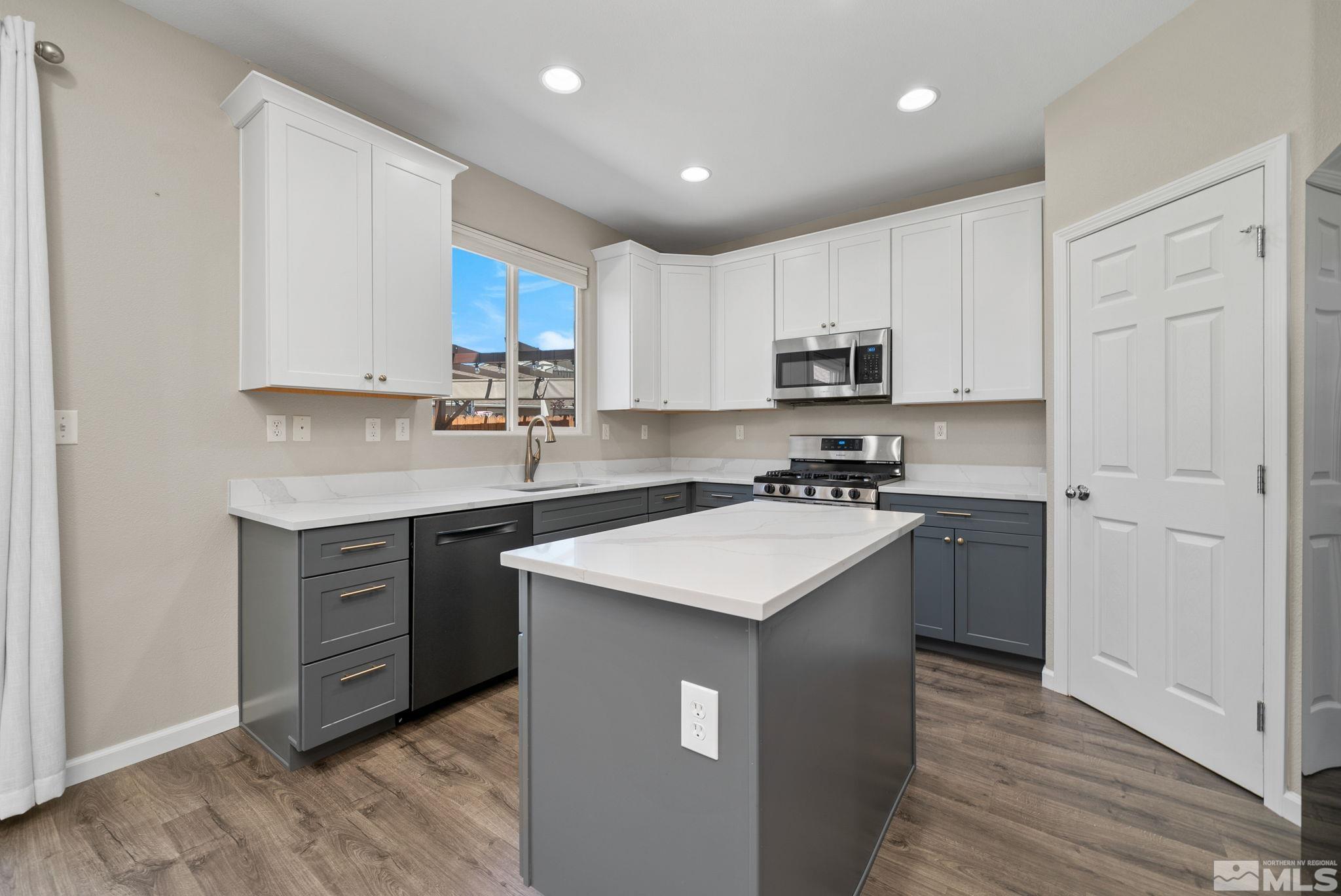 2270 Big Trail Circle Reno, NV 89521 - Photo 6 of 40 a kitchen with a sink stove top oven and cabinets