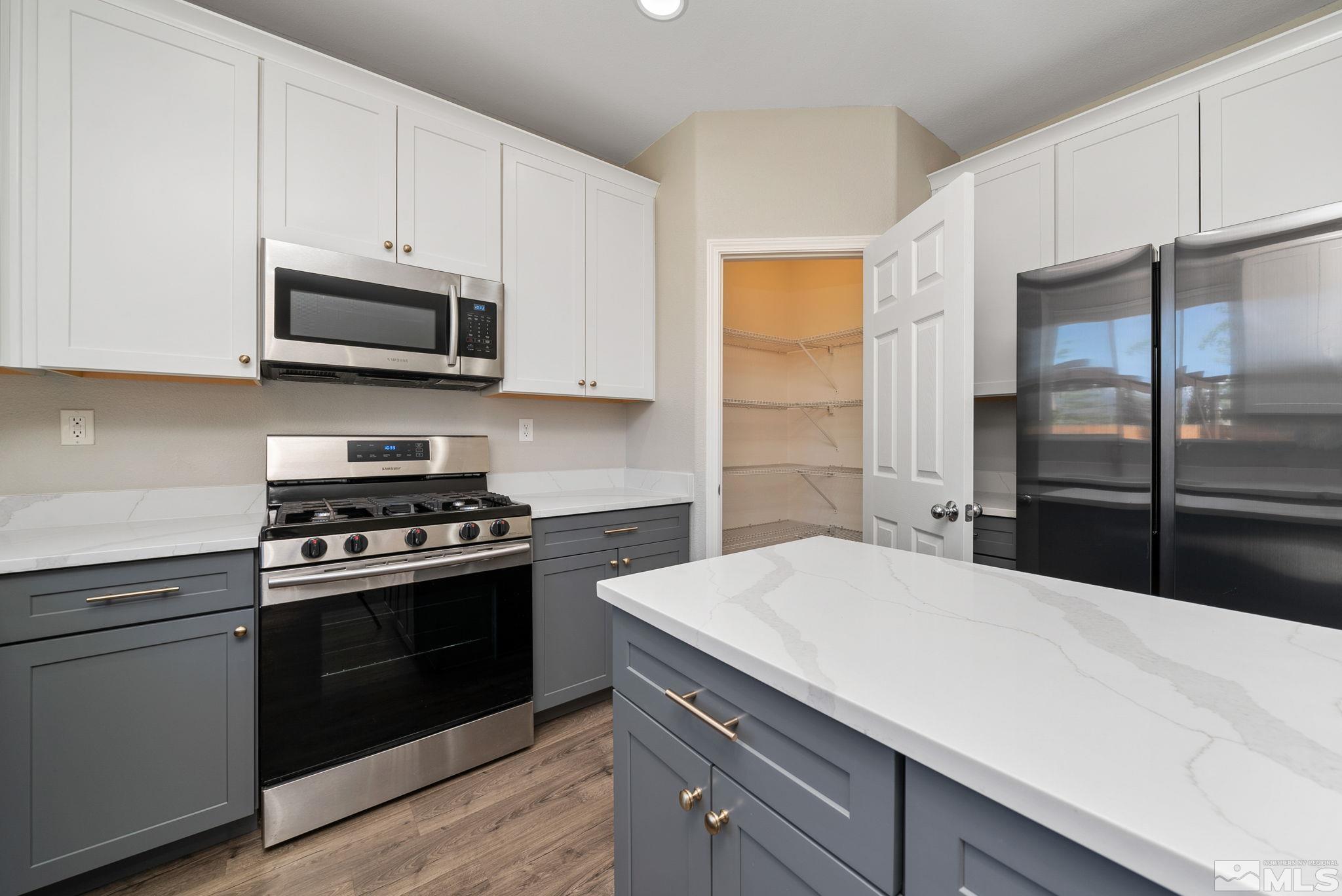 2270 Big Trail Circle Reno, NV 89521 - Photo 9 of 40 a kitchen with kitchen island white cabinets appliances and a counter space