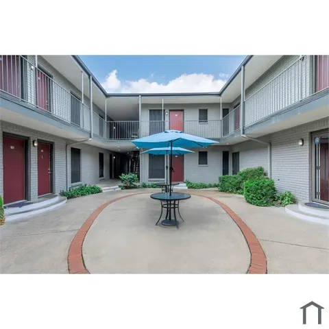 a man sitting on a bench in front of building