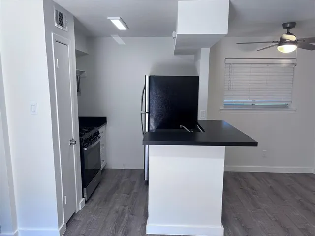 a kitchen with a refrigerator and a stove