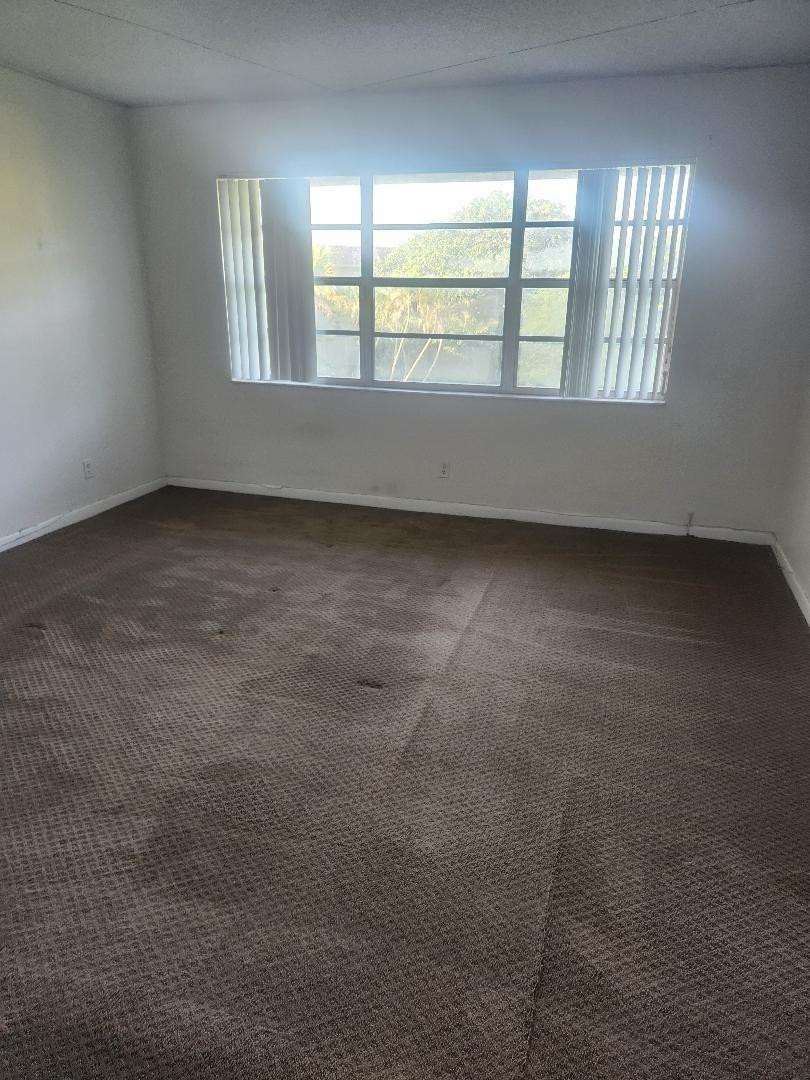 613 South State Road 7, Unit 3E Pompano Beach, FL 33068 - Photo 13 of 15 an empty room with a empty space and windows