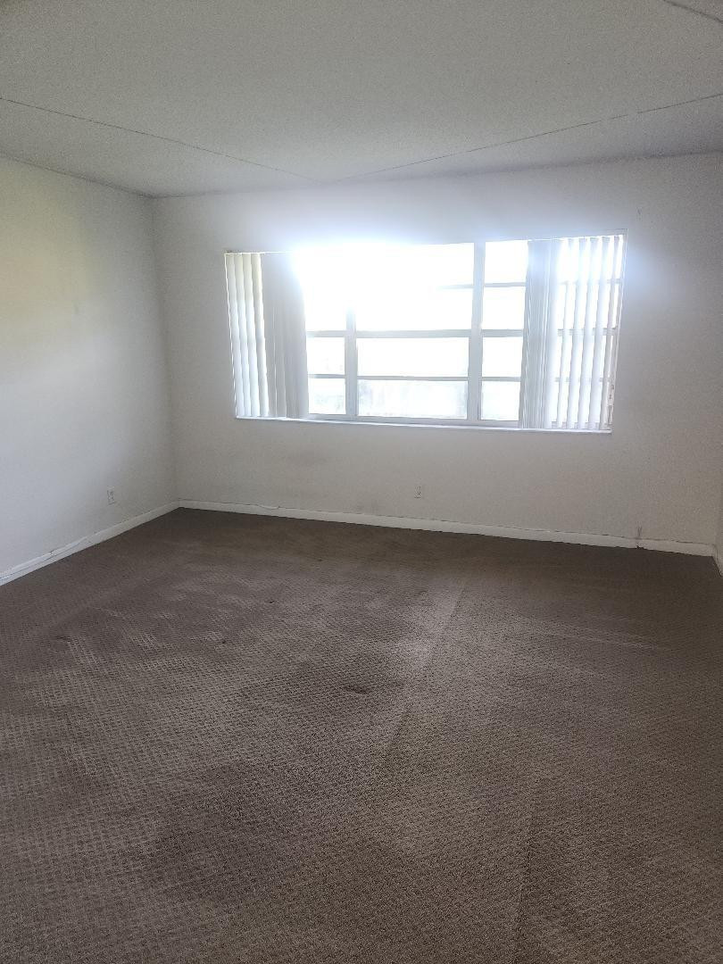 613 South State Road 7, Unit 3E Pompano Beach, FL 33068 - Photo 14 of 15 an empty room with a window