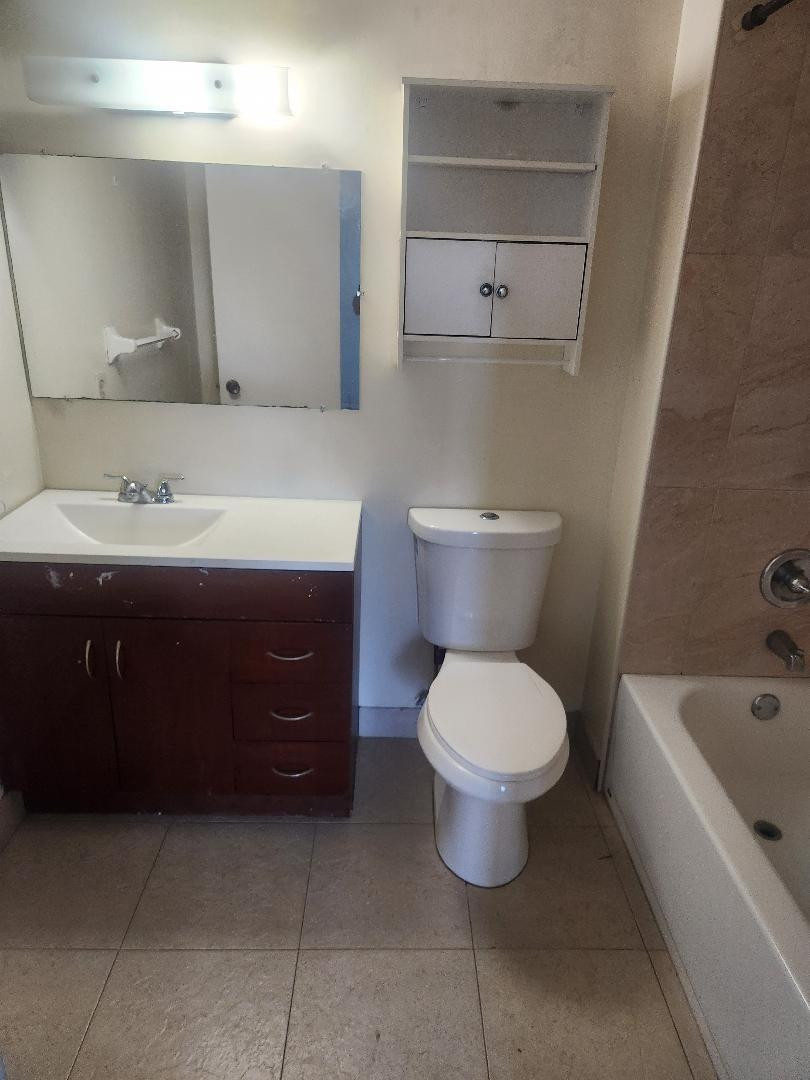 613 South State Road 7, Unit 3E Pompano Beach, FL 33068 - Photo 15 of 15 a bathroom with a toilet sink and mirror