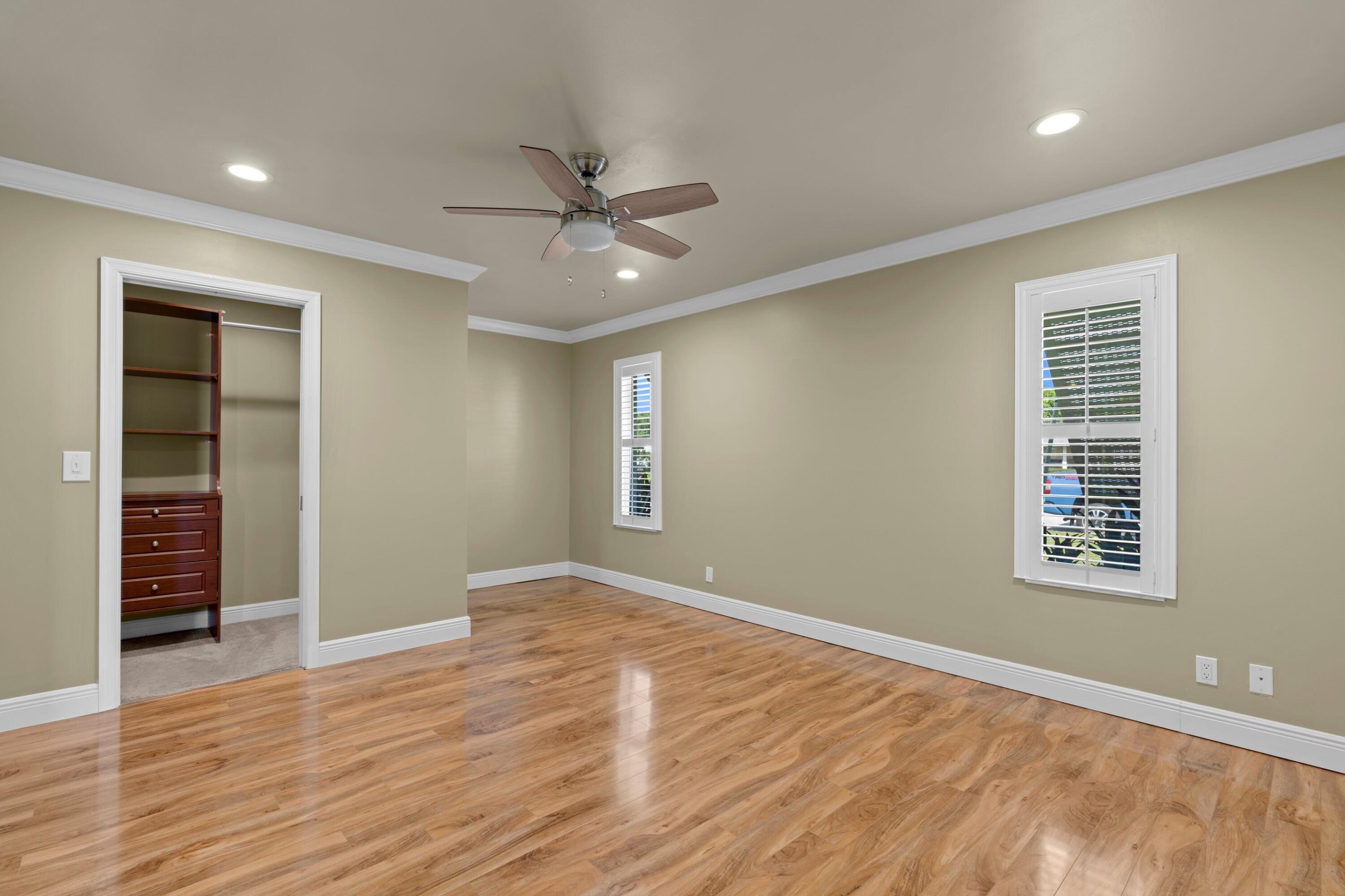 18312 Southeast Eagle Lane Jupiter, FL 33469 - Photo 11 of 17 an empty room with wooden floor closet and windows