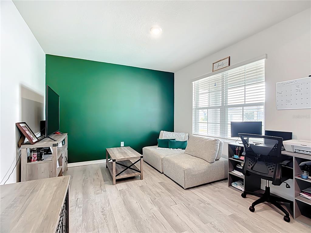 605 Honey Bell Road Winter Haven, FL 33880 - Photo 12 of 71 a living room with furniture and a flat screen tv