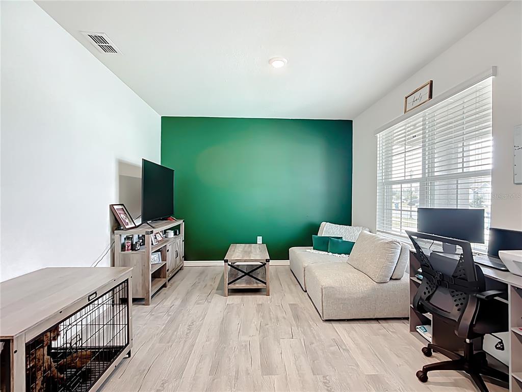 605 Honey Bell Road Winter Haven, FL 33880 - Photo 13 of 71 a living room with furniture and a flat screen tv