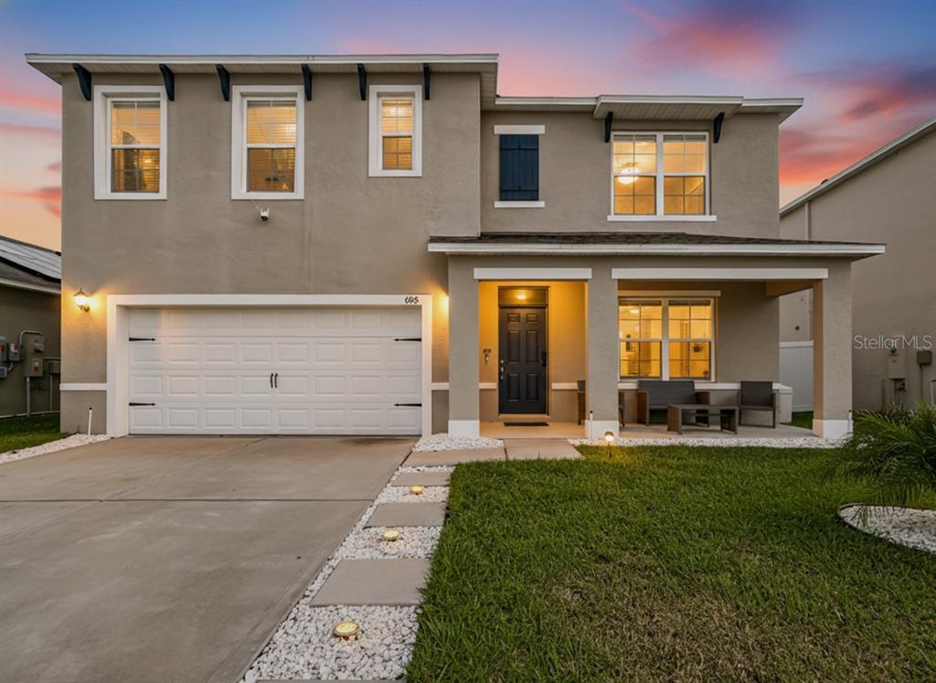605 Honey Bell Road Winter Haven, FL 33880 - Photo 2 of 73 a front view of a house with a yard and garage