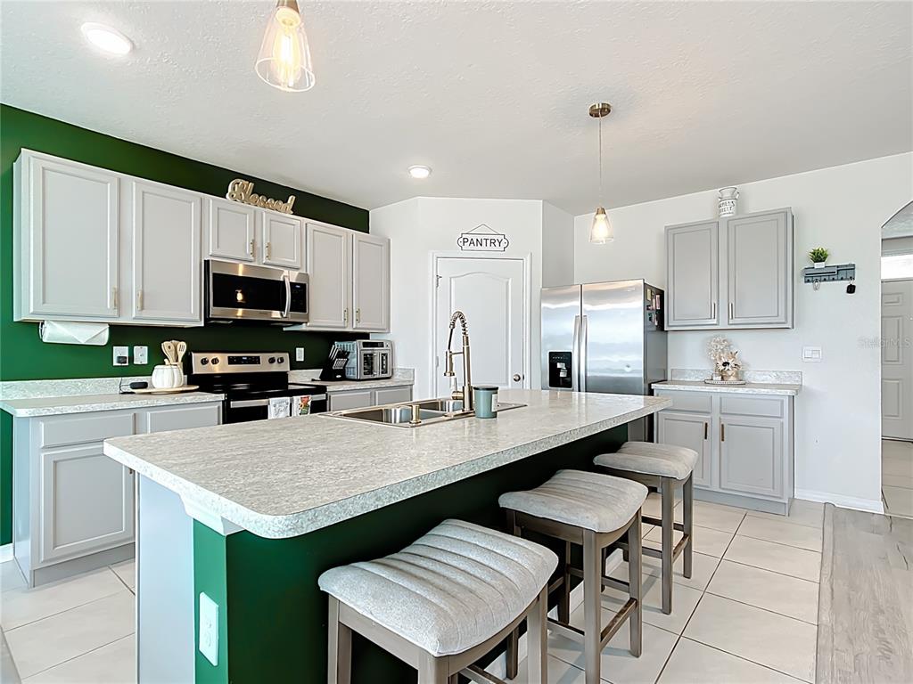 605 Honey Bell Road Winter Haven, FL 33880 - Photo 21 of 71 a kitchen with appliances a sink and cabinets