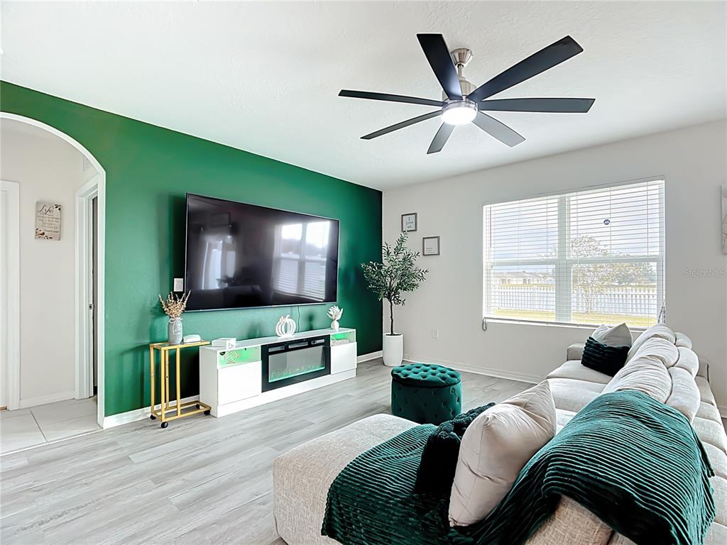 605 Honey Bell Road Winter Haven, FL 33880 - Photo 28 of 71 a living room with furniture and a flat screen tv