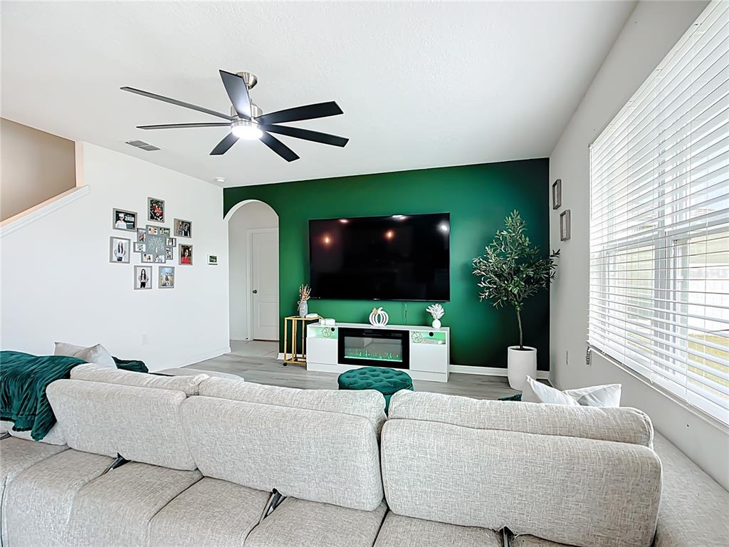 605 Honey Bell Road Winter Haven, FL 33880 - Photo 29 of 73 a living room with furniture and a flat screen tv