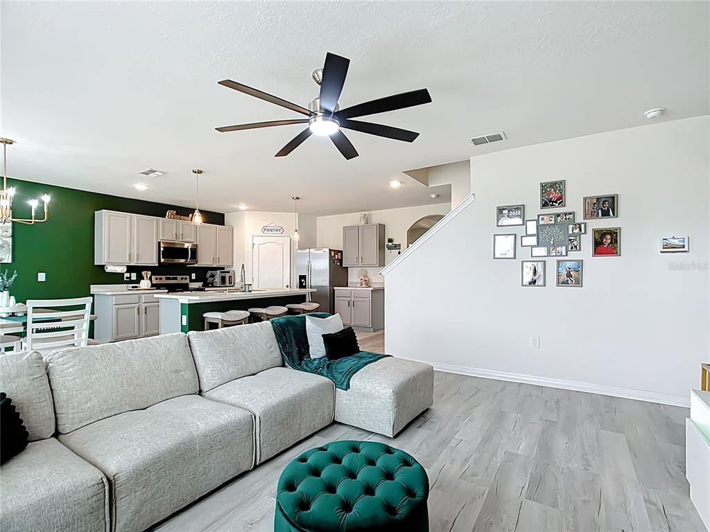 605 Honey Bell Road Winter Haven, FL 33880 - Photo 30 of 71 a living room with furniture and kitchen view