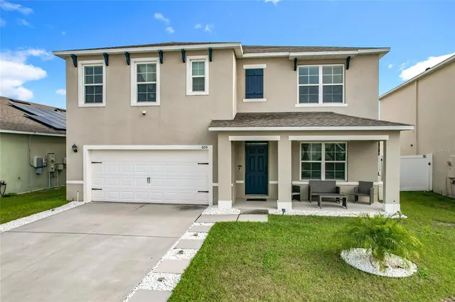 an aerial view of a house with a yard