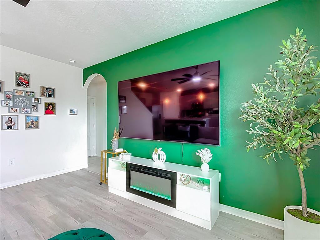 605 Honey Bell Road Winter Haven, FL 33880 - Photo 33 of 73 a living room with furniture and a flat screen tv