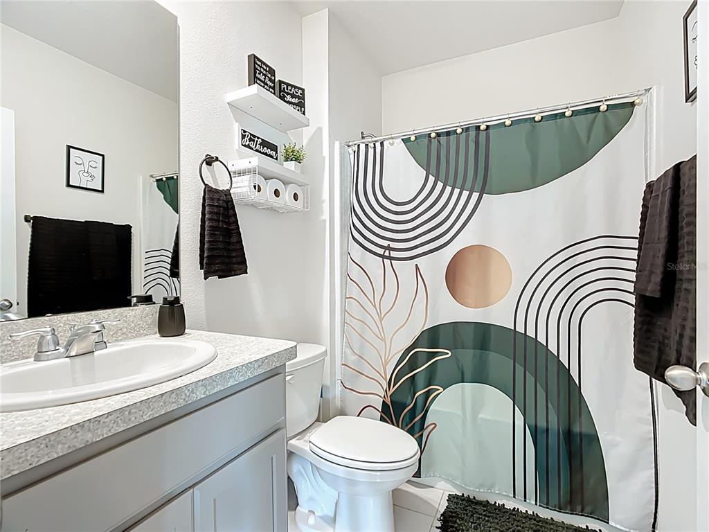 605 Honey Bell Road Winter Haven, FL 33880 - Photo 35 of 71 a bathroom with a sink a toilet and a mirror