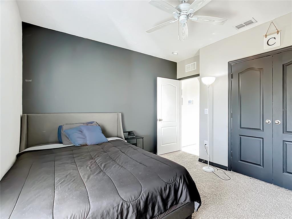 605 Honey Bell Road Winter Haven, FL 33880 - Photo 36 of 73 a bedroom with a bed and a ceiling fan